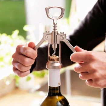 Wing corkscrew wine opener used to remove cork from bottle